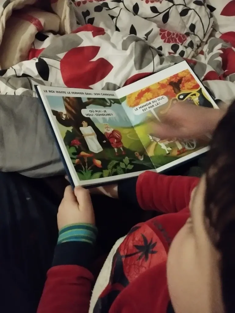 A child reading a Céline Alvarez story with his mother